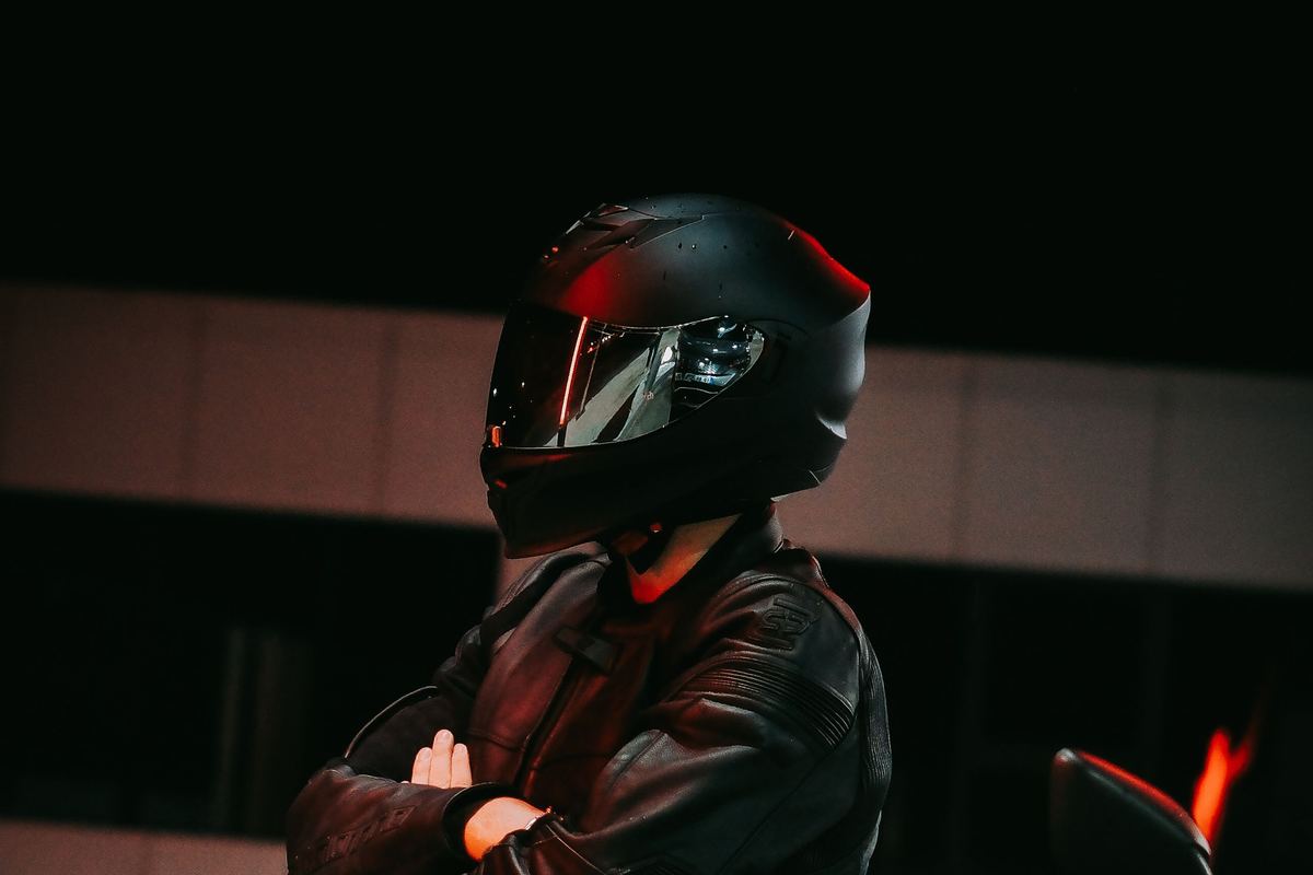 Moto circulando de noche por una calle iluminada de ciudad.